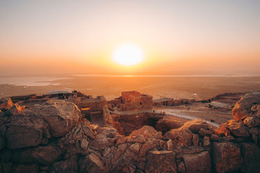 sunrise over stone buildings in golden light