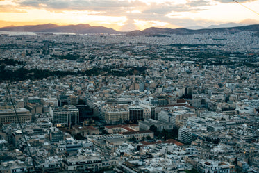 sunset against a city with hills in the background