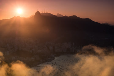 sunset behind a tall mountain and nearby town