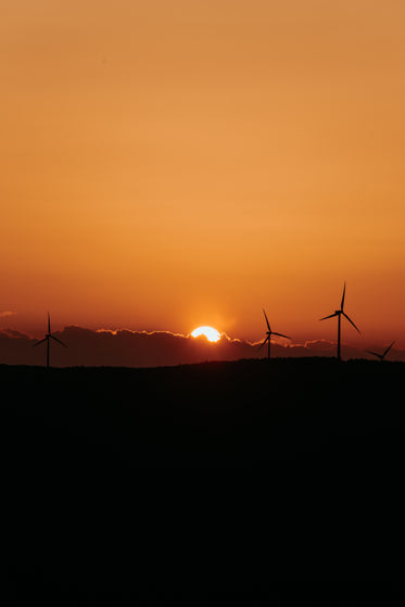 sunset behind fluffy cloud silhouetting the landscape