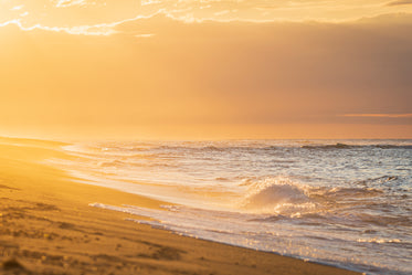 sunset creates orange hue along the beach