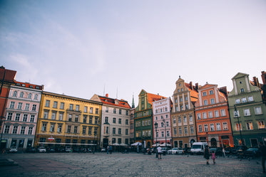 sunset on a european town square lined with colourful buildings