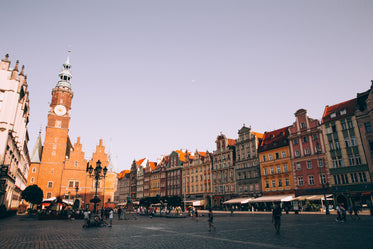 sunset over a red brick tower in a cobbled piazza