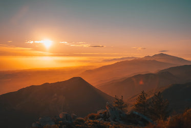 sunset over foggy mountains