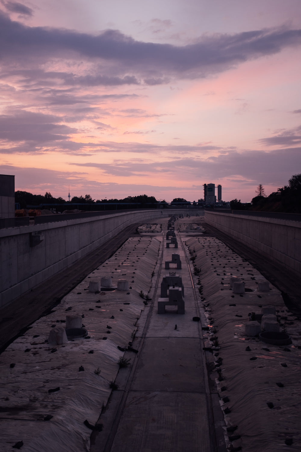 sunsets on a large cement pathway lined with flowers