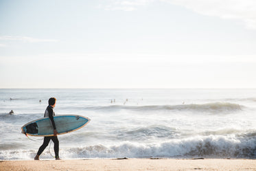 surfer carrying board