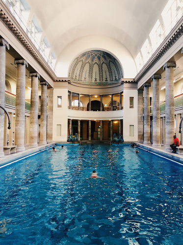 swimming pool with ornate ceiling and columns