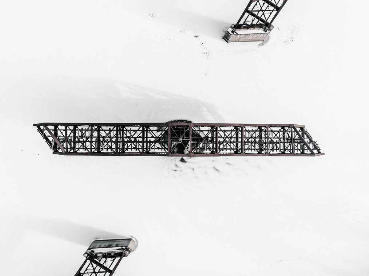 swing bridge locked in place in a frozen river surrounded by snow