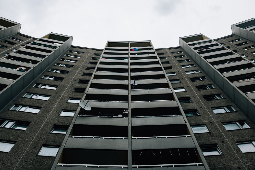 symmetrical apartment building under clouds