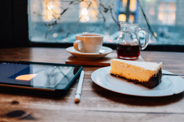 tablet and pen with coffee and cake