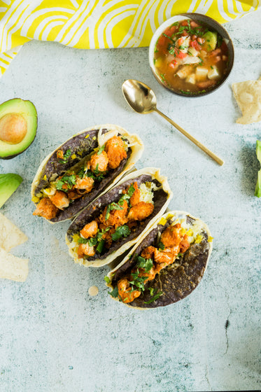 taco shells with black beans and fried chicken