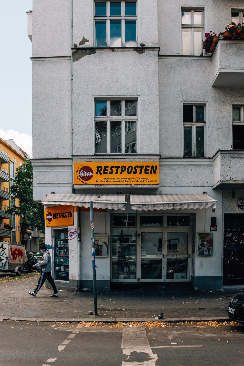 tall building with an orange sign that says restposten