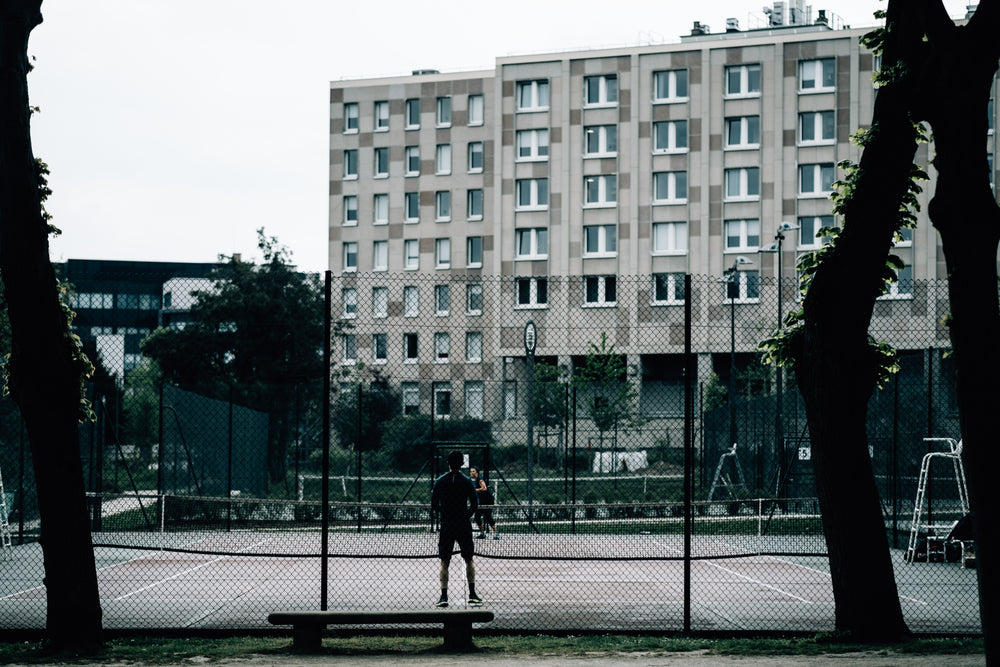 tall buildings with tennis courts in front