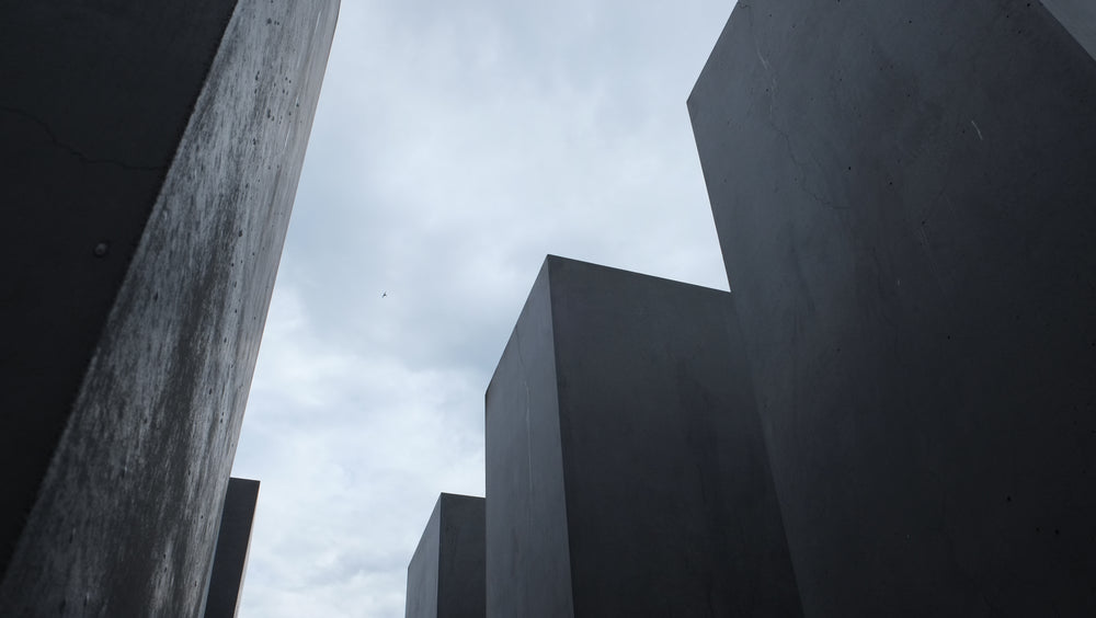 tall cement blocks against a cloudy sky