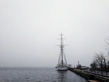 tall ship docked in fog
