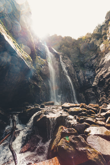 tall waterfall over large rocky surface