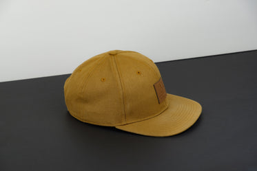 tan colored hat on monochrome background
