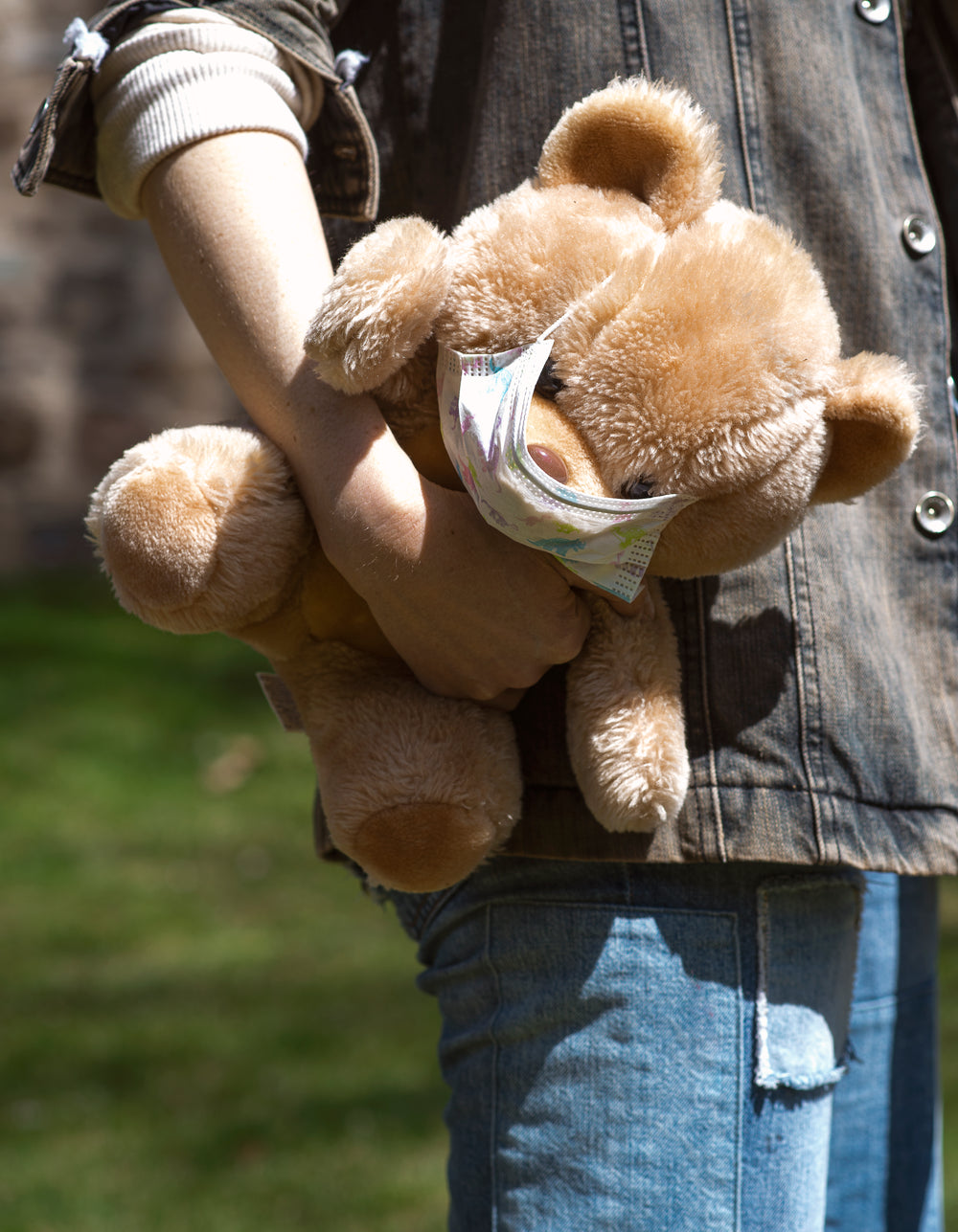 tan teddy bear with face mask