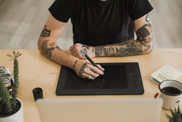 tattood man using creative technology