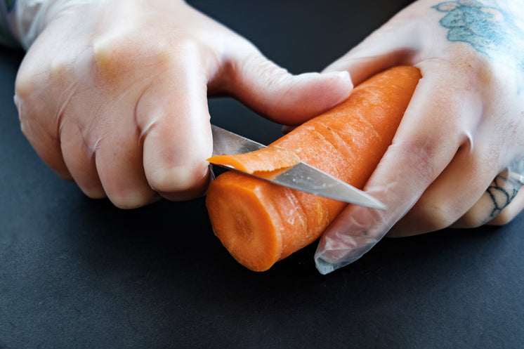 tattooed-hands-cut-a-carrot.jpg?width=74