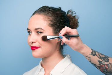 tattooed makeup artist at work