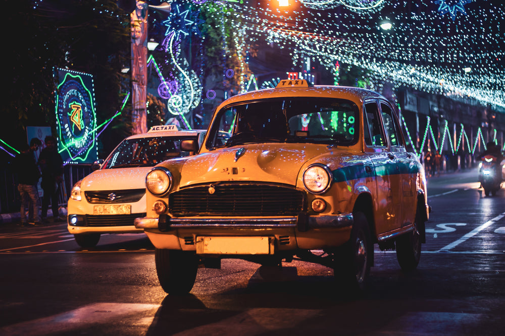 taxi light with strings of lights at night