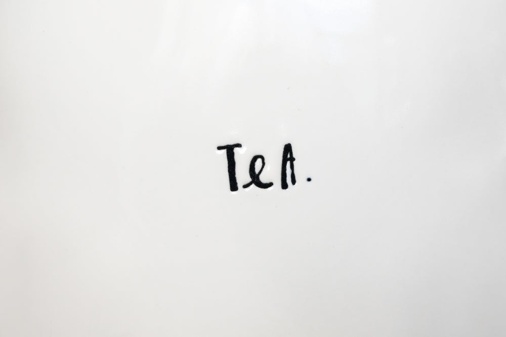 tea lettering on white ceramic