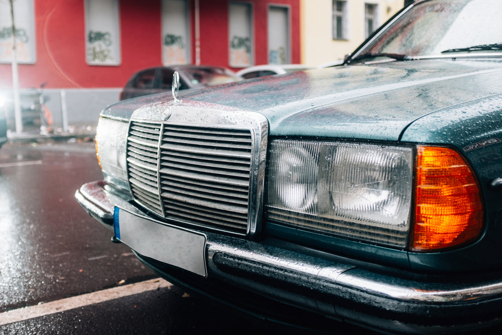 teal car in the rain