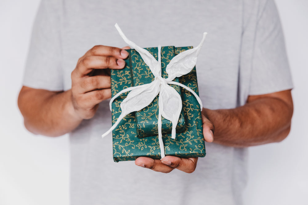 teal gift wrap with white ribbon