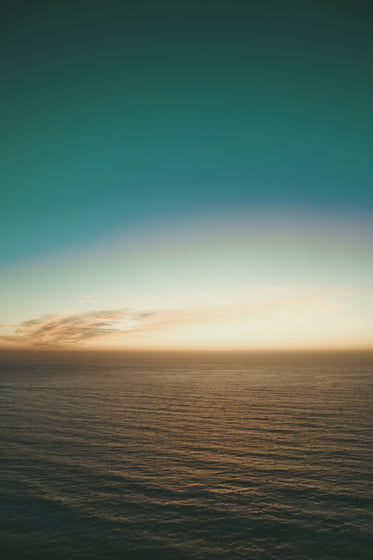 teal sky over calm evening waters