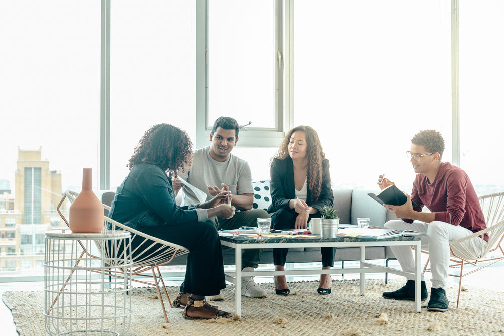 team brainstorm meeting in bright sunny office