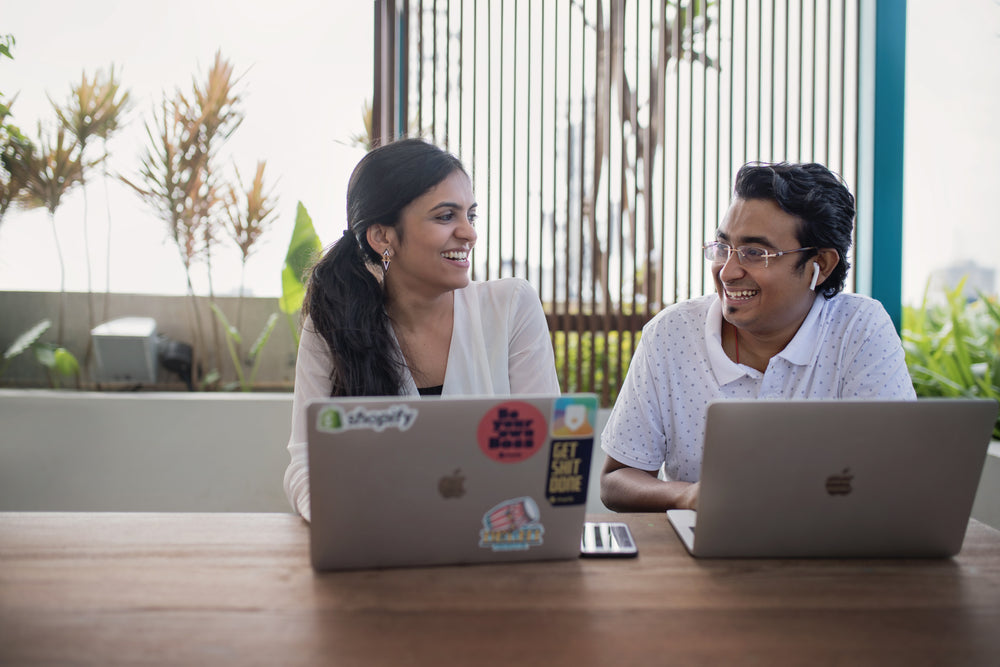 team shares a laugh in modern coworking space in india