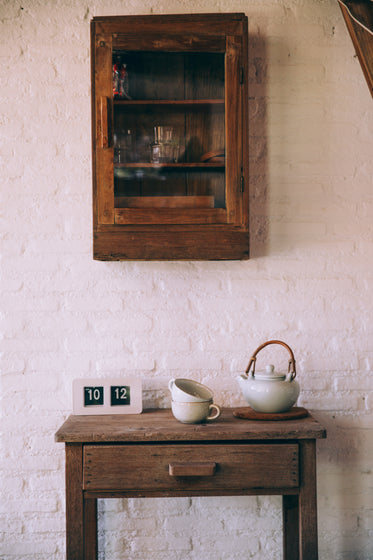 teapot and cups on side table