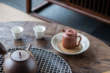 teapot and two tea cups on wooden table