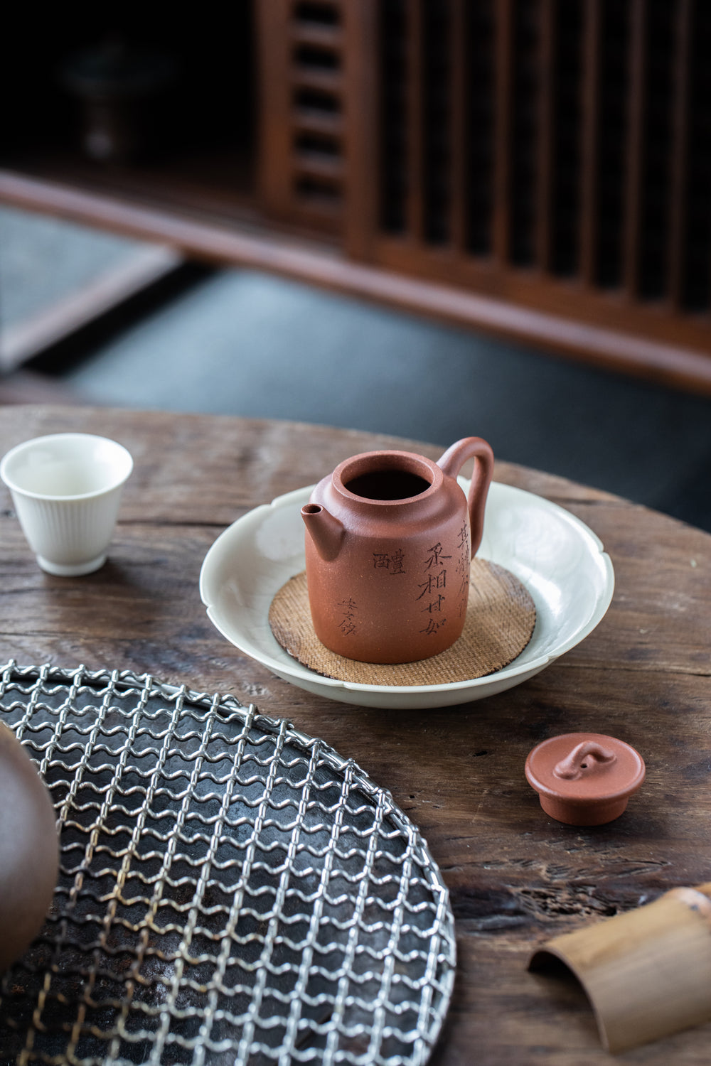 teapot without the lid on the white plate