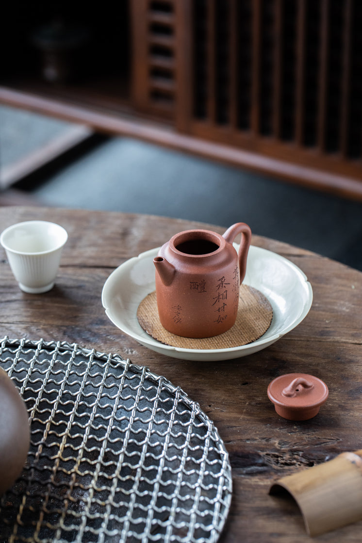 Teapot Without The Lid On The White Plate