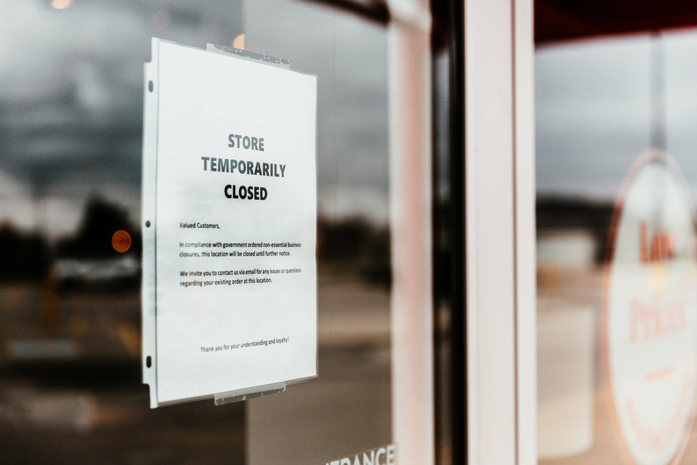 temporarily closed sign on store front