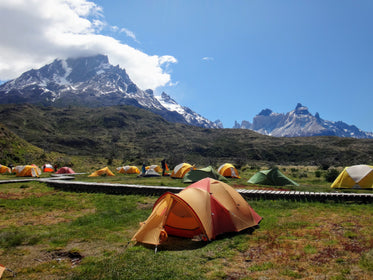 tents surround boardwalk by mountains