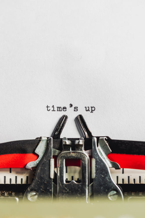 text on typewriter states 'time's up'