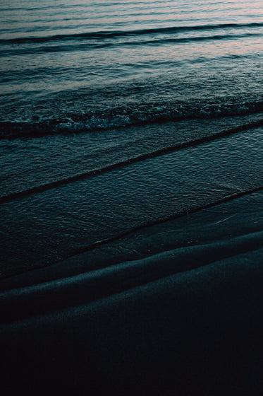 texture of dark waves on the shore