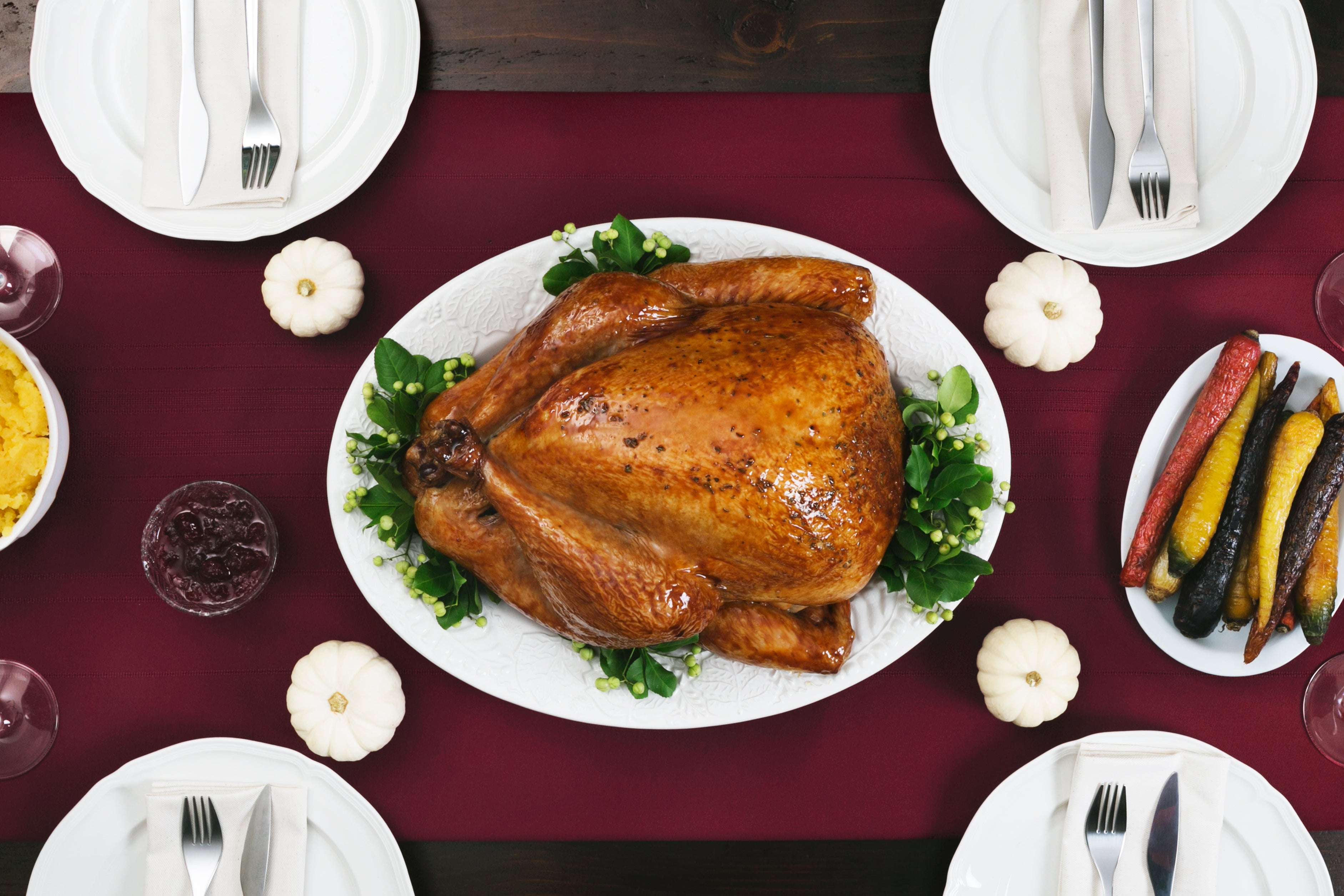 Thanksgiving dinner table with roasted turkey and seasonal side dishes