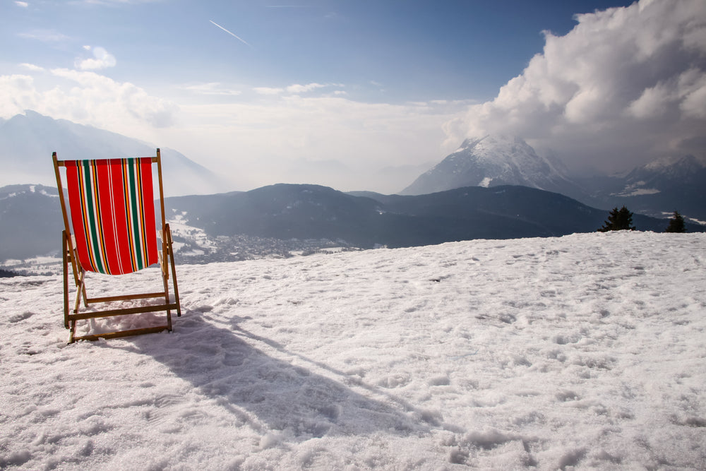 the back of a beach chair looking out to snow covered mountains
