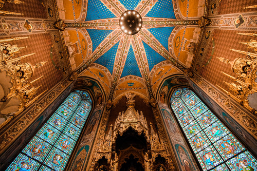 the ceiling of a church in gold and blue
