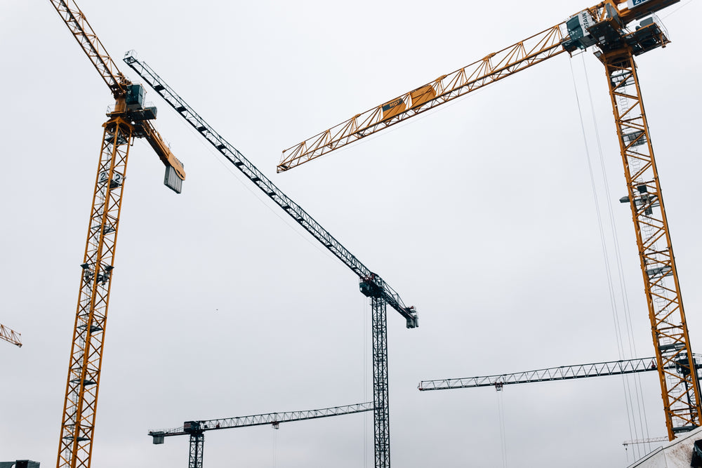 the cranes loom over the horizon from above