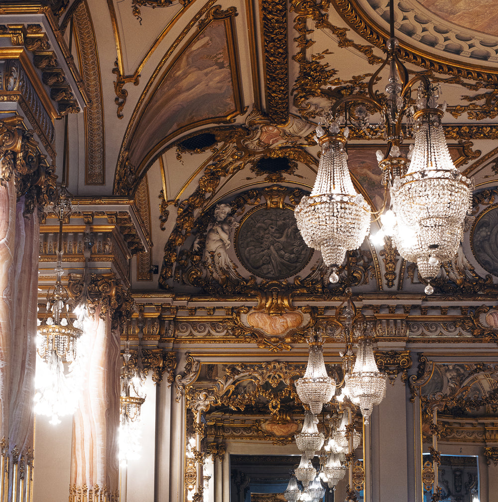 the decor of a large hall with glittering chandeliers