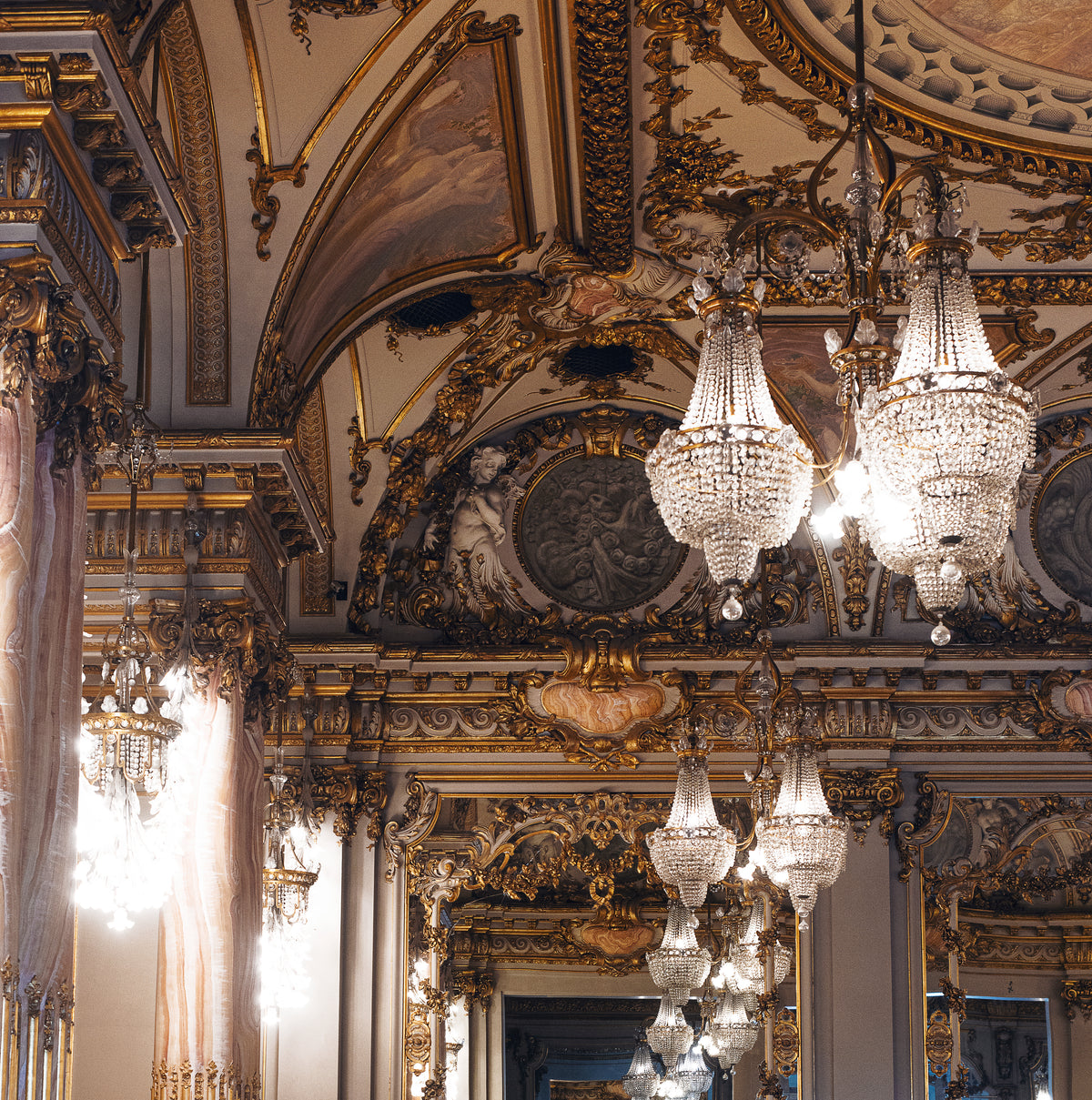 the decor of a large hall with glittering chandeliers