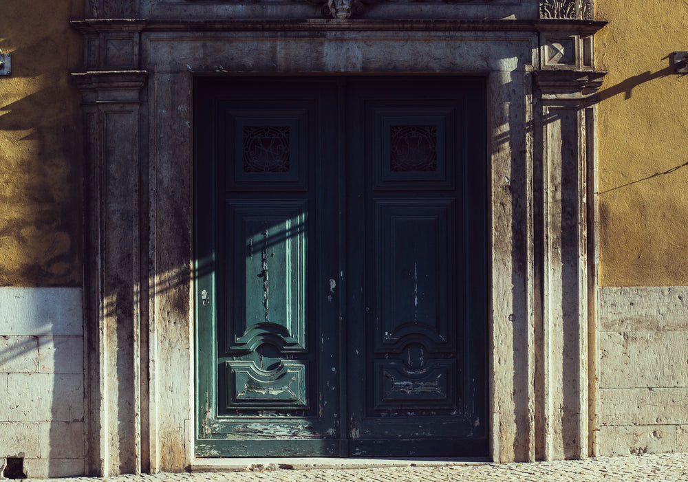 the door of a historical building catching the light