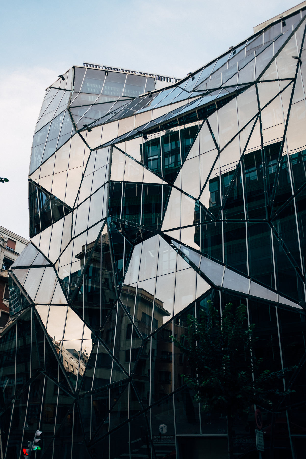 the geometric jutting shapes of a mirrored urban facade