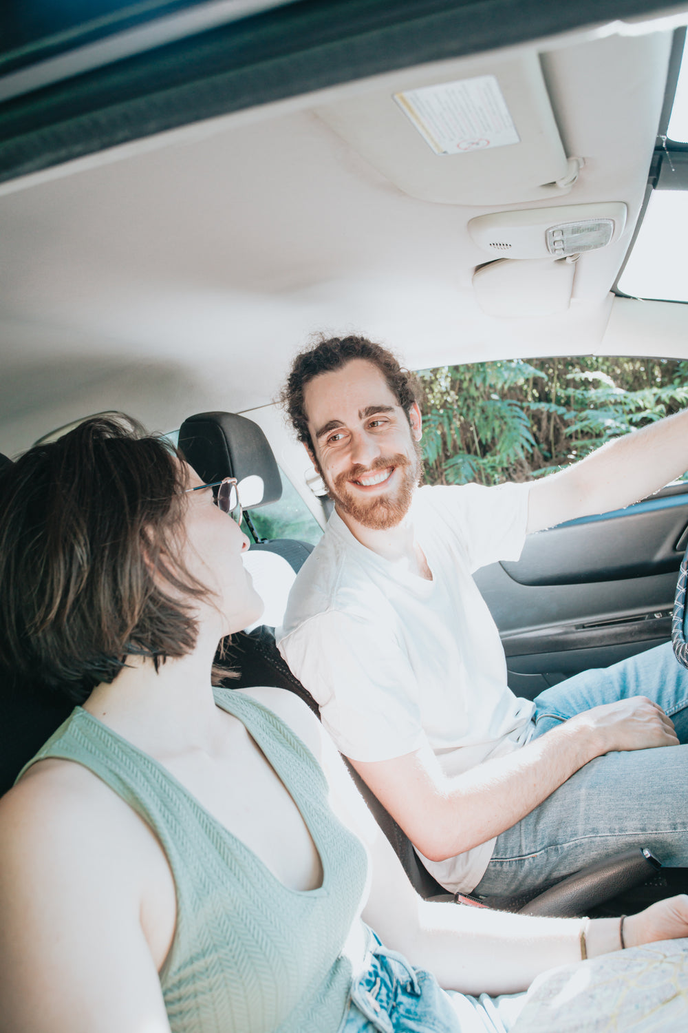 the inside of a vehicle with people smiling together