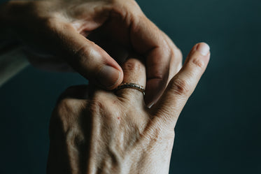 the left hand adjusts a ring on the right hand